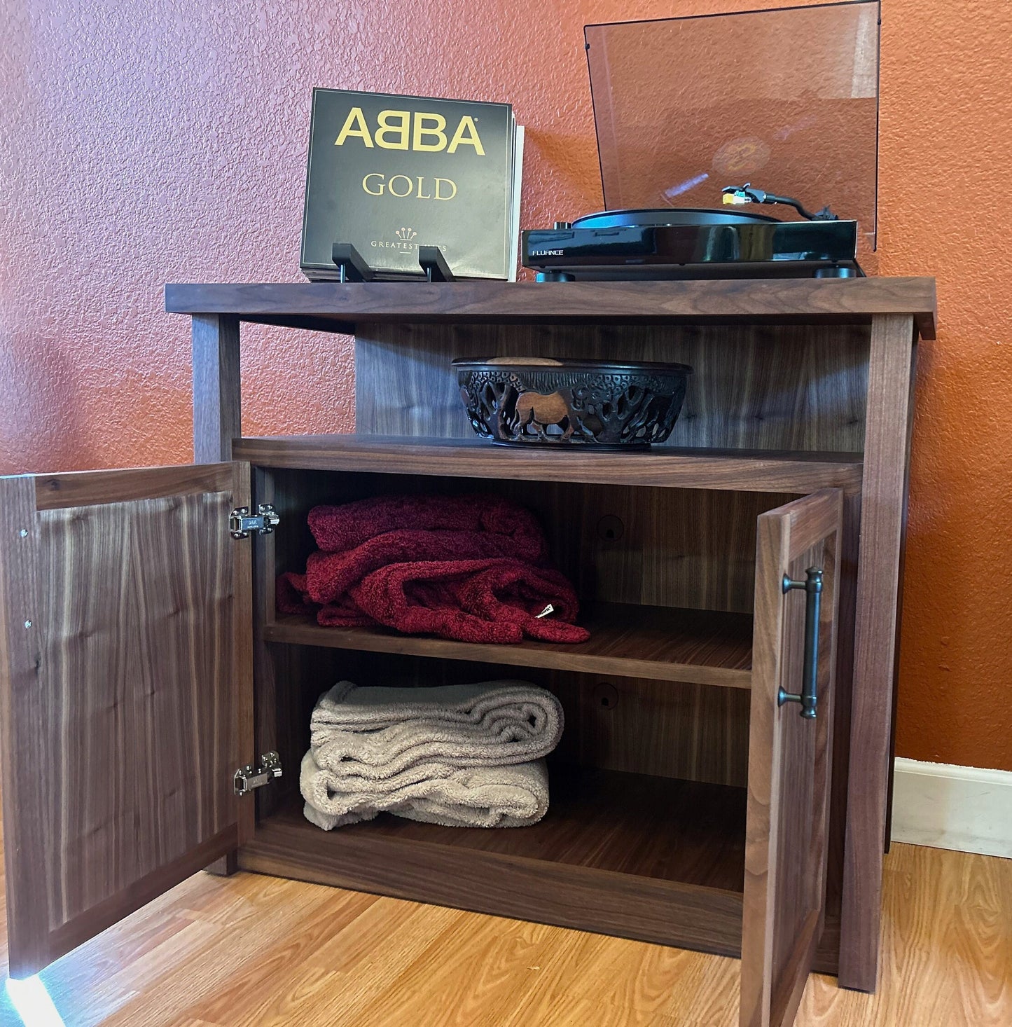 cabinet_with_open_doors_and_visible_storage_items
