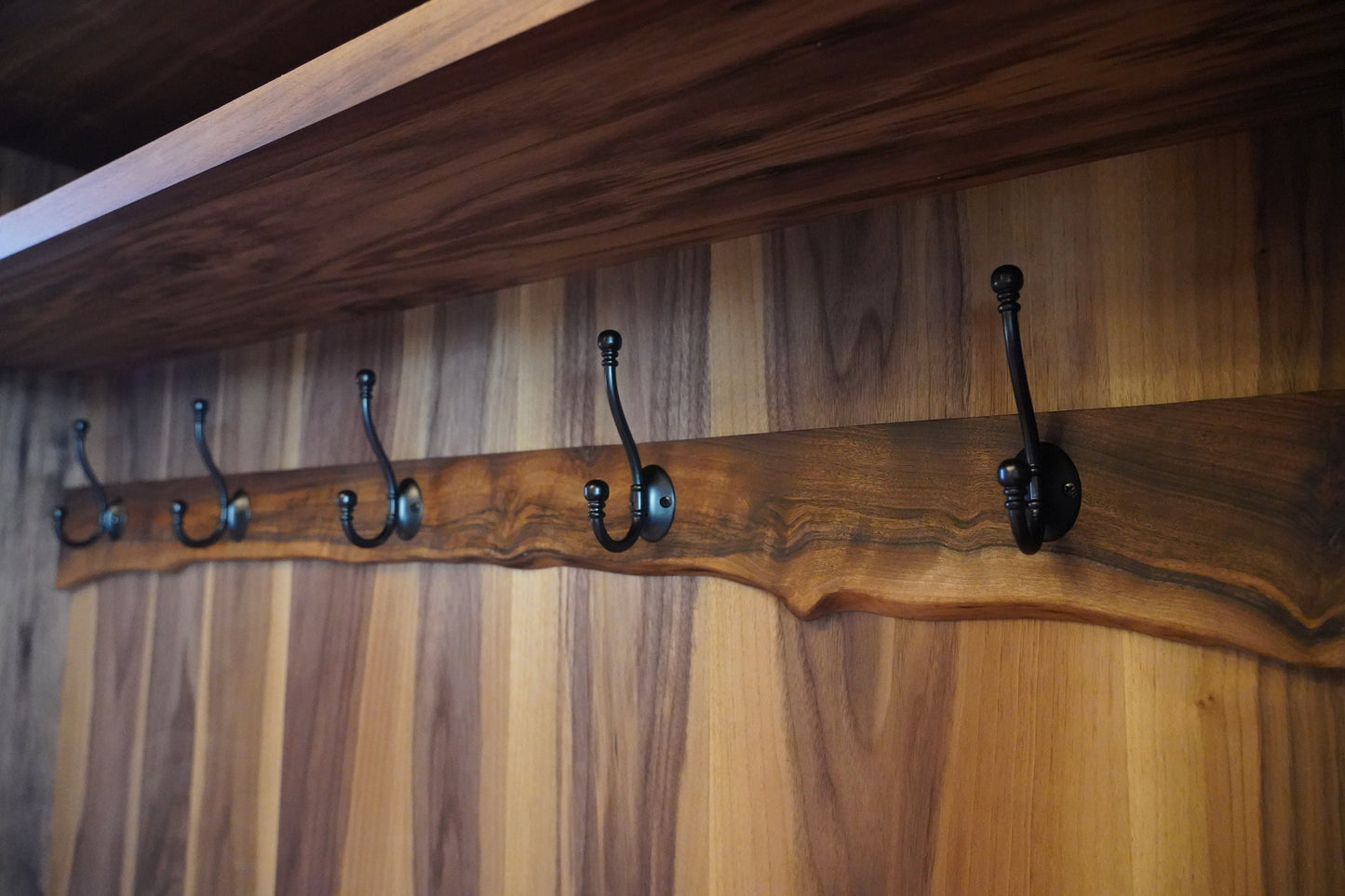 closeup_view_of_walnut_live_edge_top_and_metal_hooks