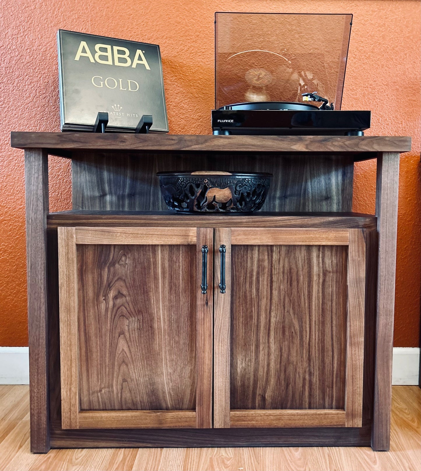 tv_unit_setup_on_top_of_wood_storage_cabinet
