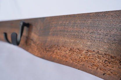 close_up_of_hooks_on_live_edge_walnut_wood_grain